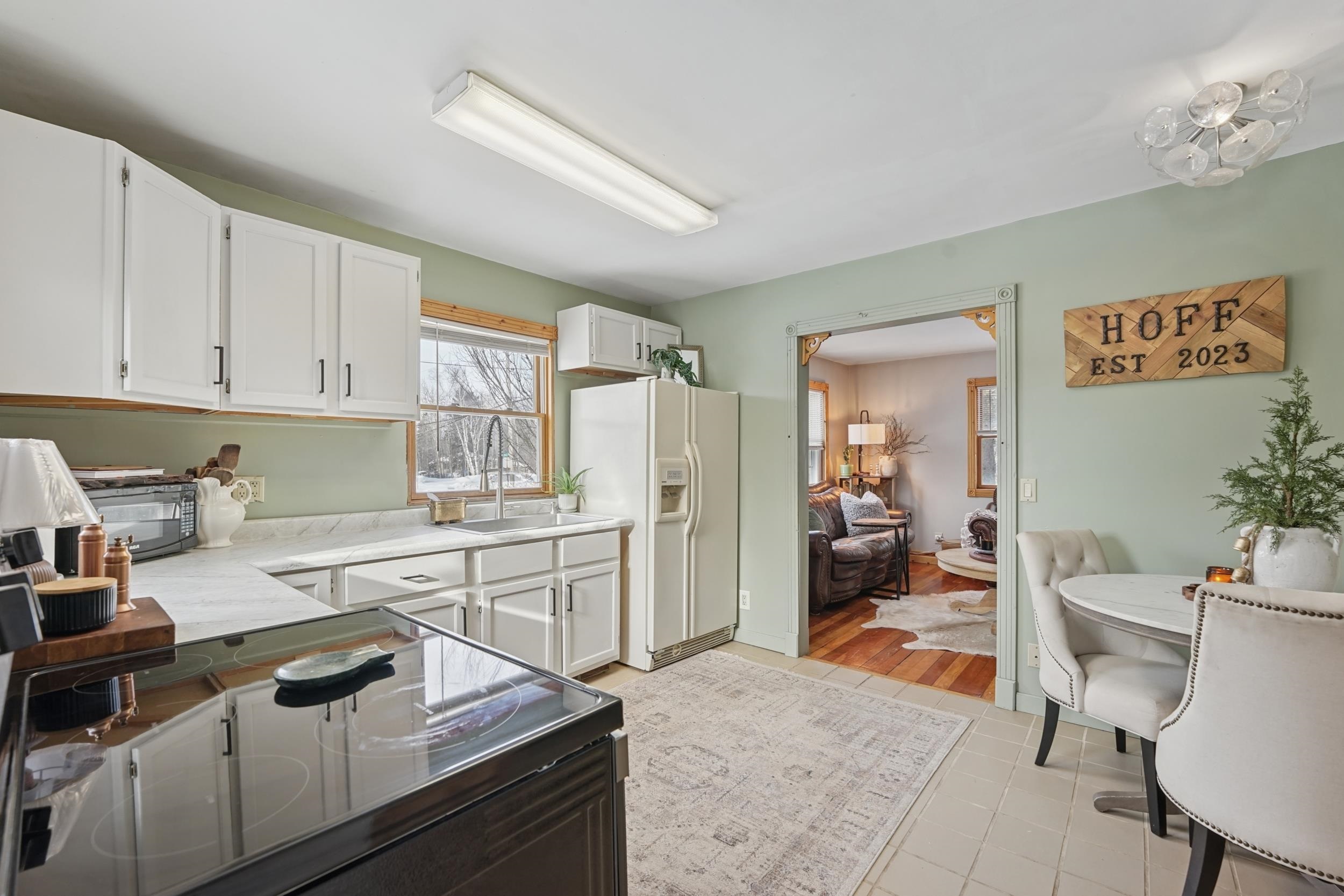52 Thomson Road Esko, MN 55733 - Photo 5 of 20 Kitchen featuring white cabinetry, electric range, white refrigerator with ice dispenser, light countertops, and light tile patterned floors