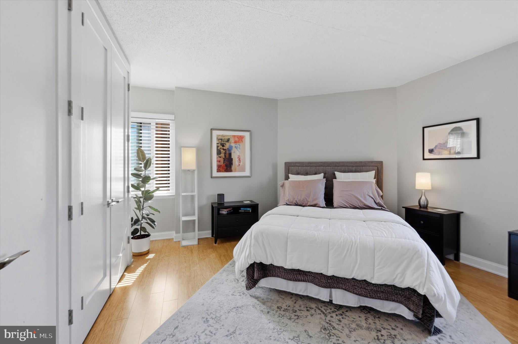 2301 Cherry Street, Unit 4A Philadelphia, PA 19103 - Photo 19 of 25 a spacious bedroom with a bed and wooden floor
