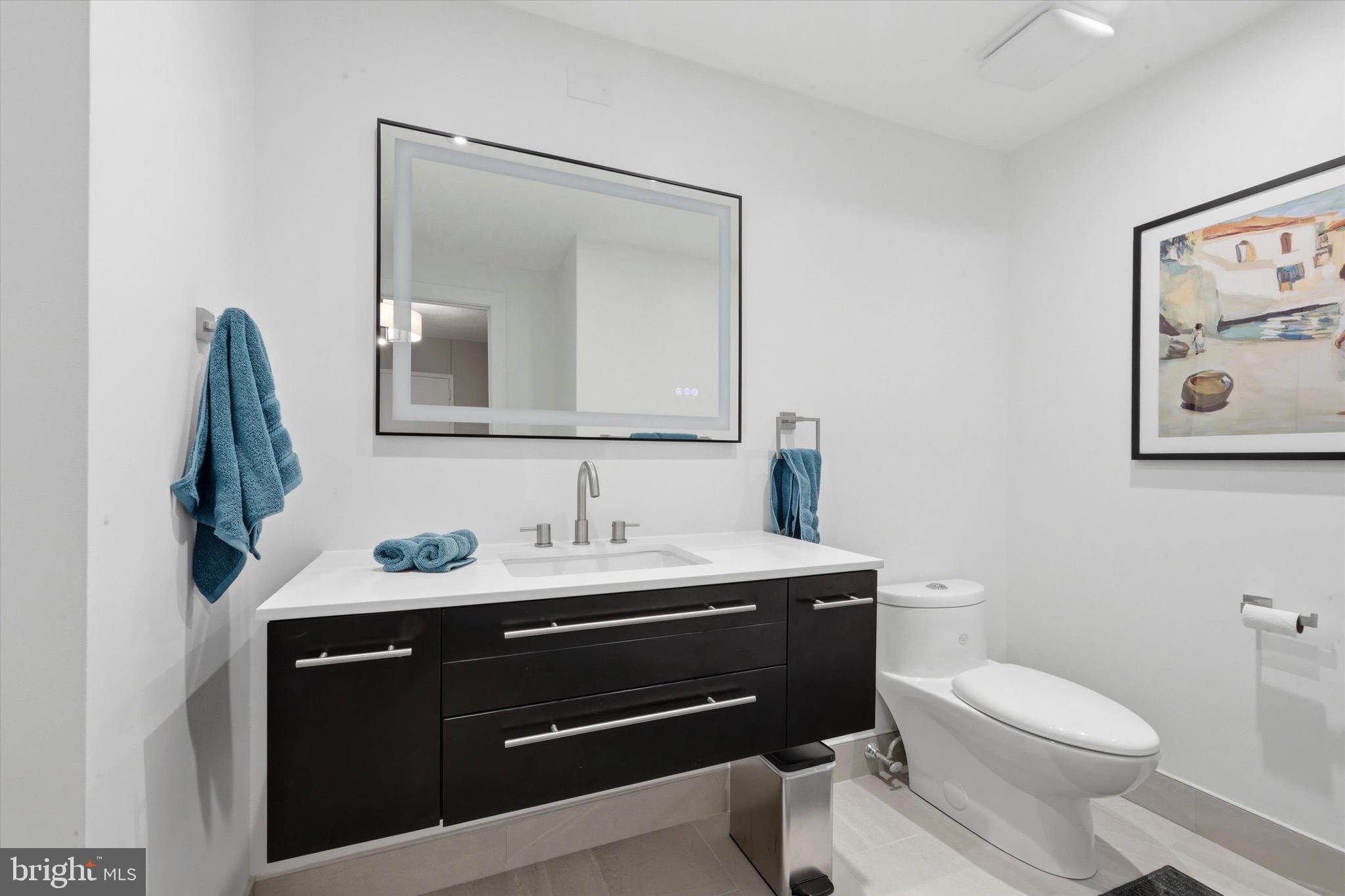 2301 Cherry Street, Unit 4A Philadelphia, PA 19103 - Photo 5 of 25 a bathroom with a toilet sink and mirror