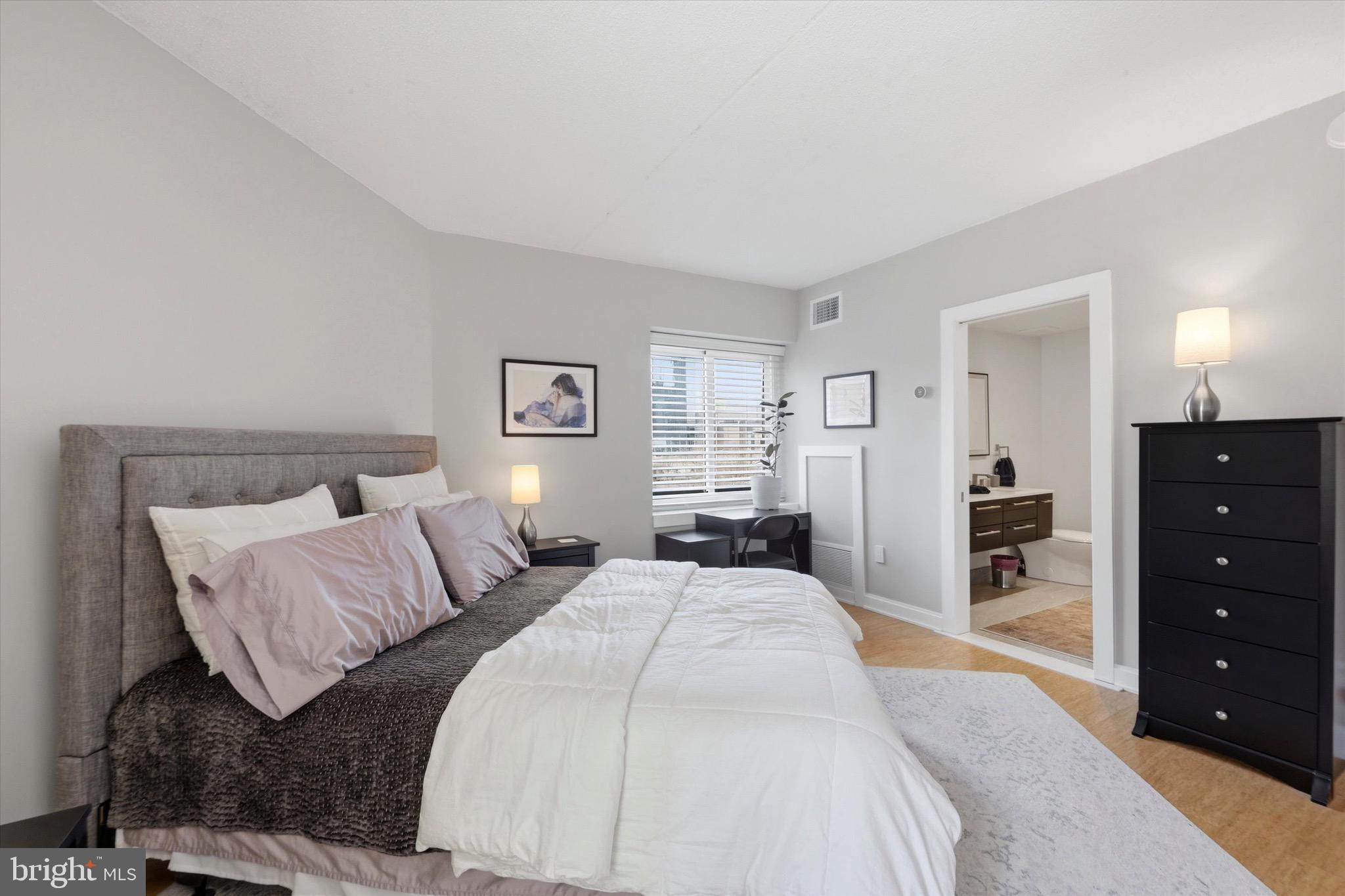 2301 Cherry Street, Unit 4A Philadelphia, PA 19103 - Photo 6 of 25 a spacious bedroom with a bed and a dresser