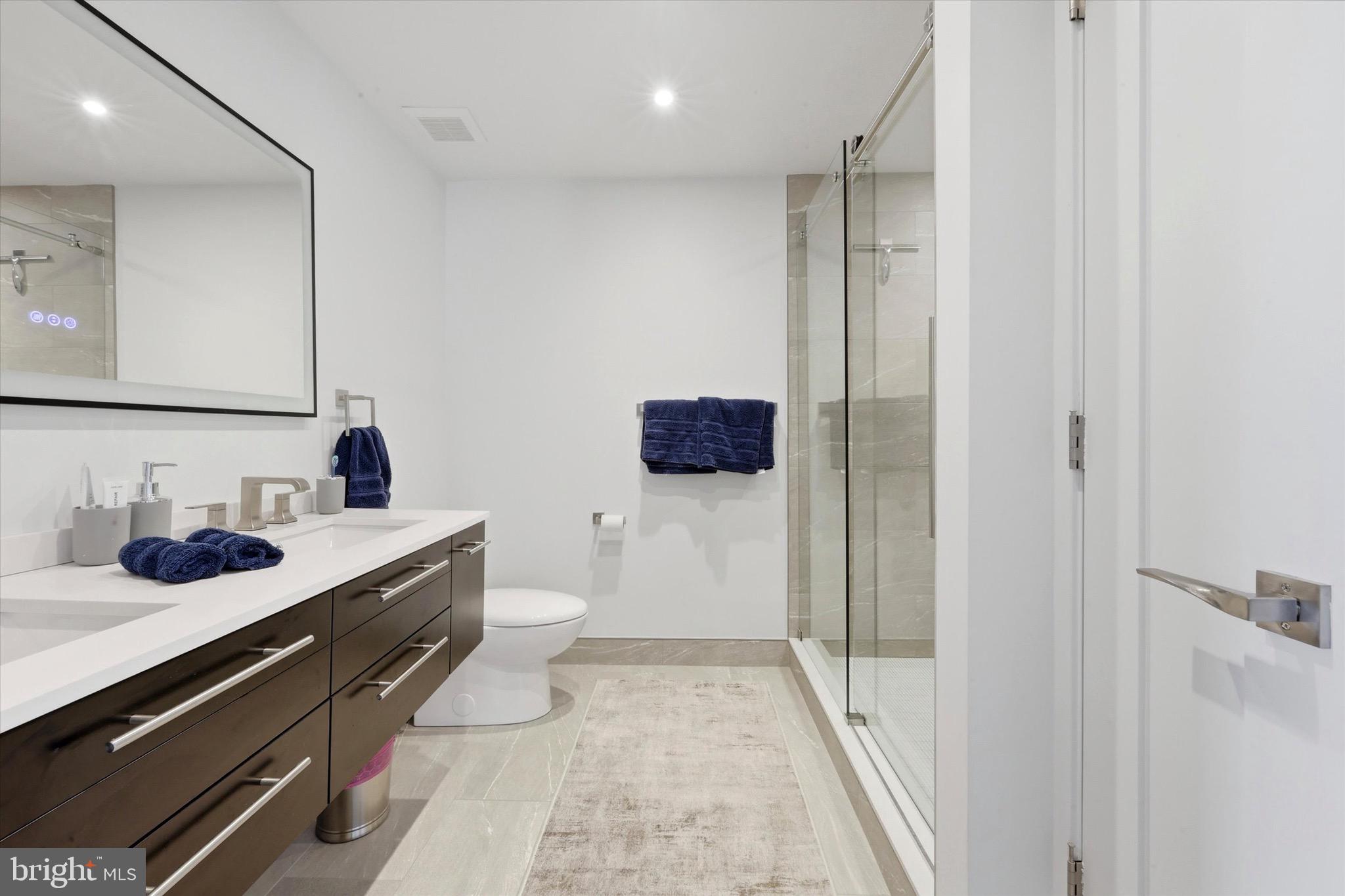 2301 Cherry Street, Unit 4A Philadelphia, PA 19103 - Photo 7 of 25 a bathroom with a sink and mirror