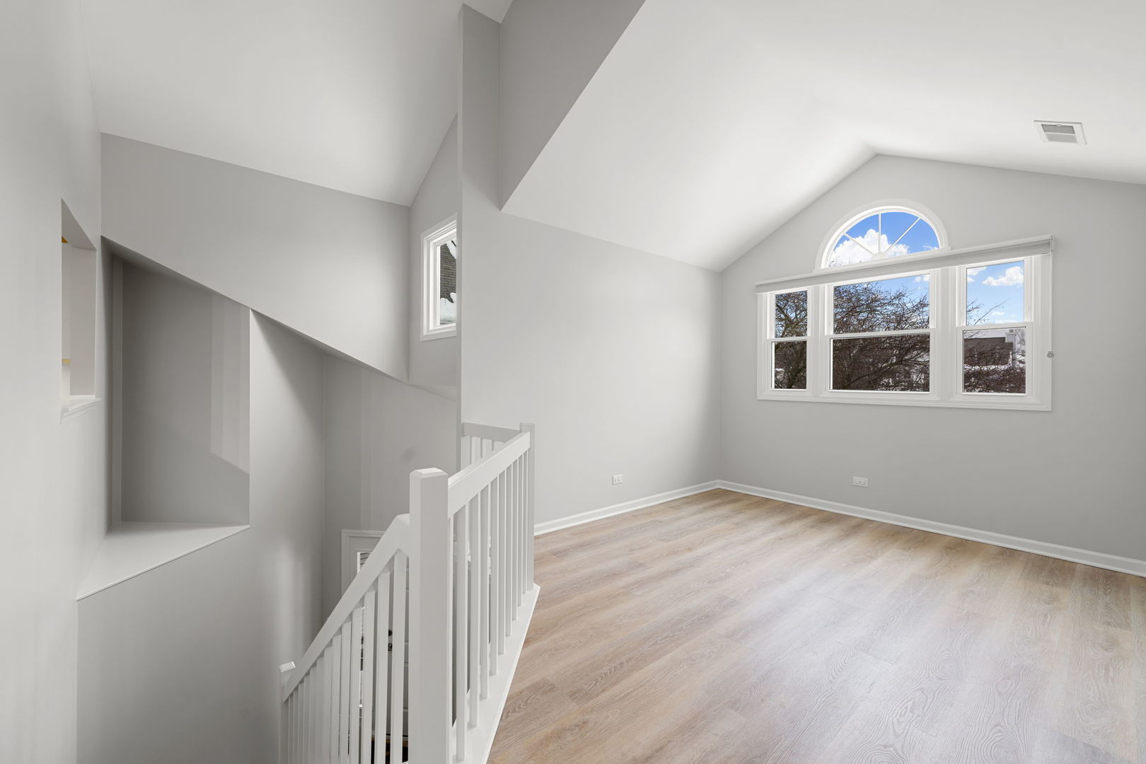 1264 Rhodes Lane Naperville, IL 60540 - Photo 14 of 35 a view of an empty room with wooden floor and stairs