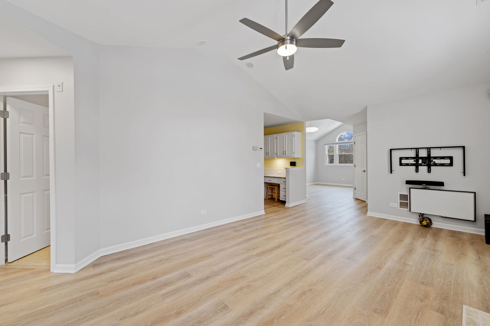 1264 Rhodes Lane Naperville, IL 60540 - Photo 15 of 35 an empty room with wooden floor a ceiling fan and windows