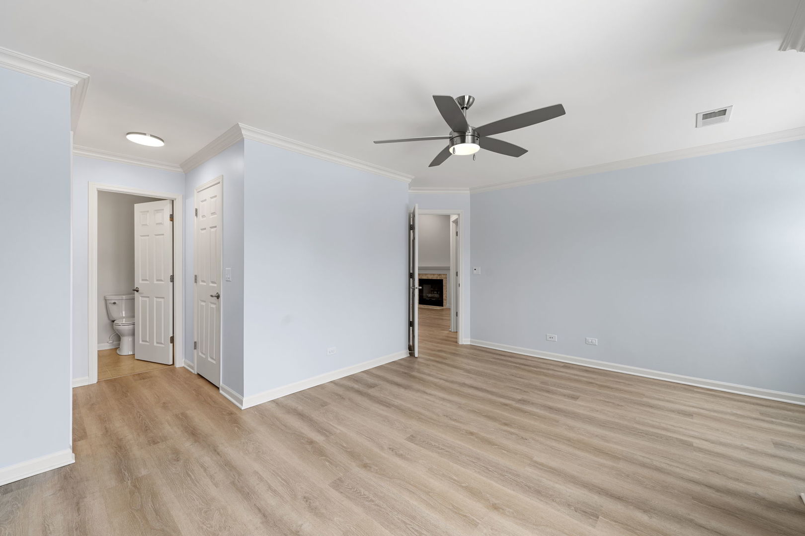 1264 Rhodes Lane Naperville, IL 60540 - Photo 24 of 35 a view of empty room with wooden floor and ceiling fan