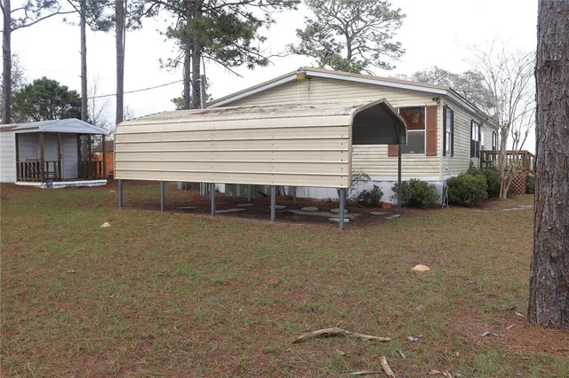 a view of a white house with a yard