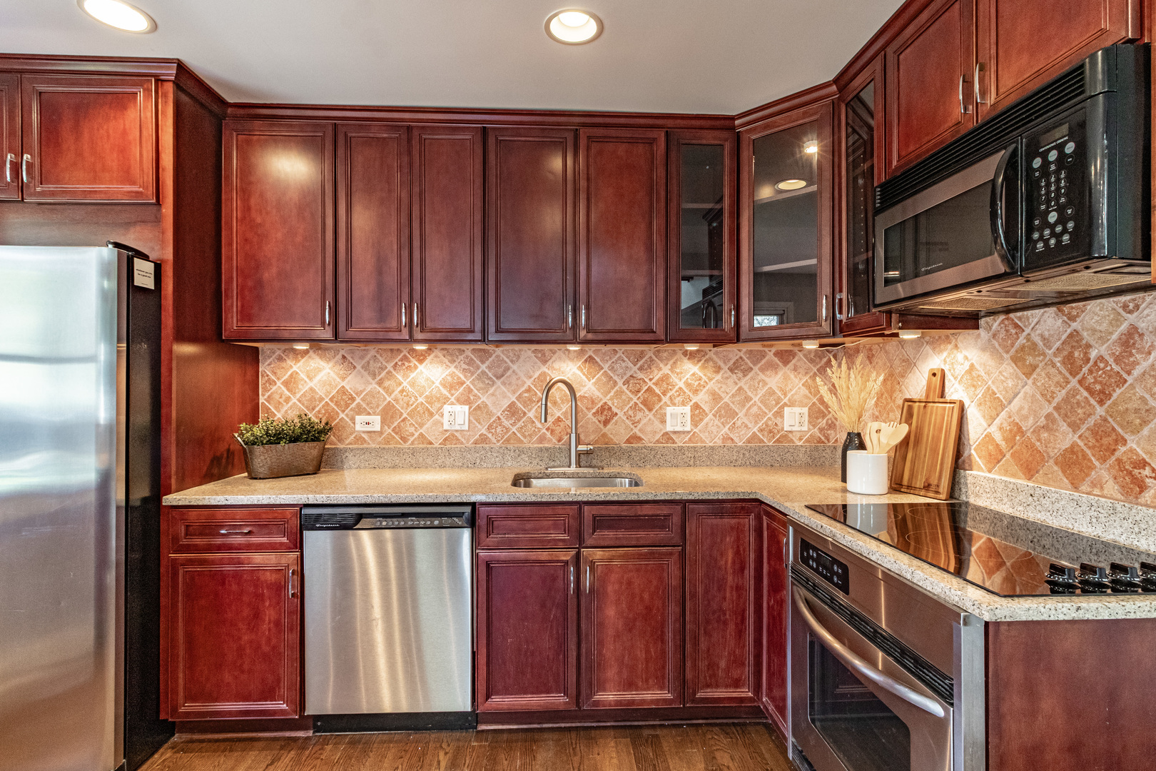 1979 Dundee Road Northbrook, IL 60062 - Photo 11 of 28 a kitchen with stainless steel appliances granite countertop wooden cabinets a refrigerator and a sink