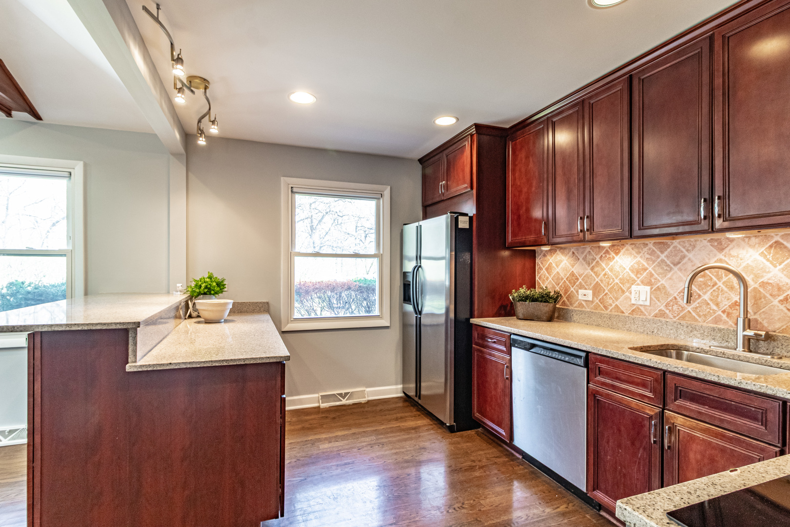 1979 Dundee Road Northbrook, IL 60062 - Photo 12 of 28 a kitchen with granite countertop stainless steel appliances sink microwave and window