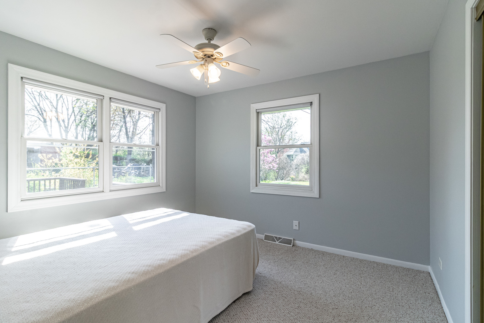 1979 Dundee Road Northbrook, IL 60062 - Photo 13 of 28 a spacious bedroom with a bed and a chandelier