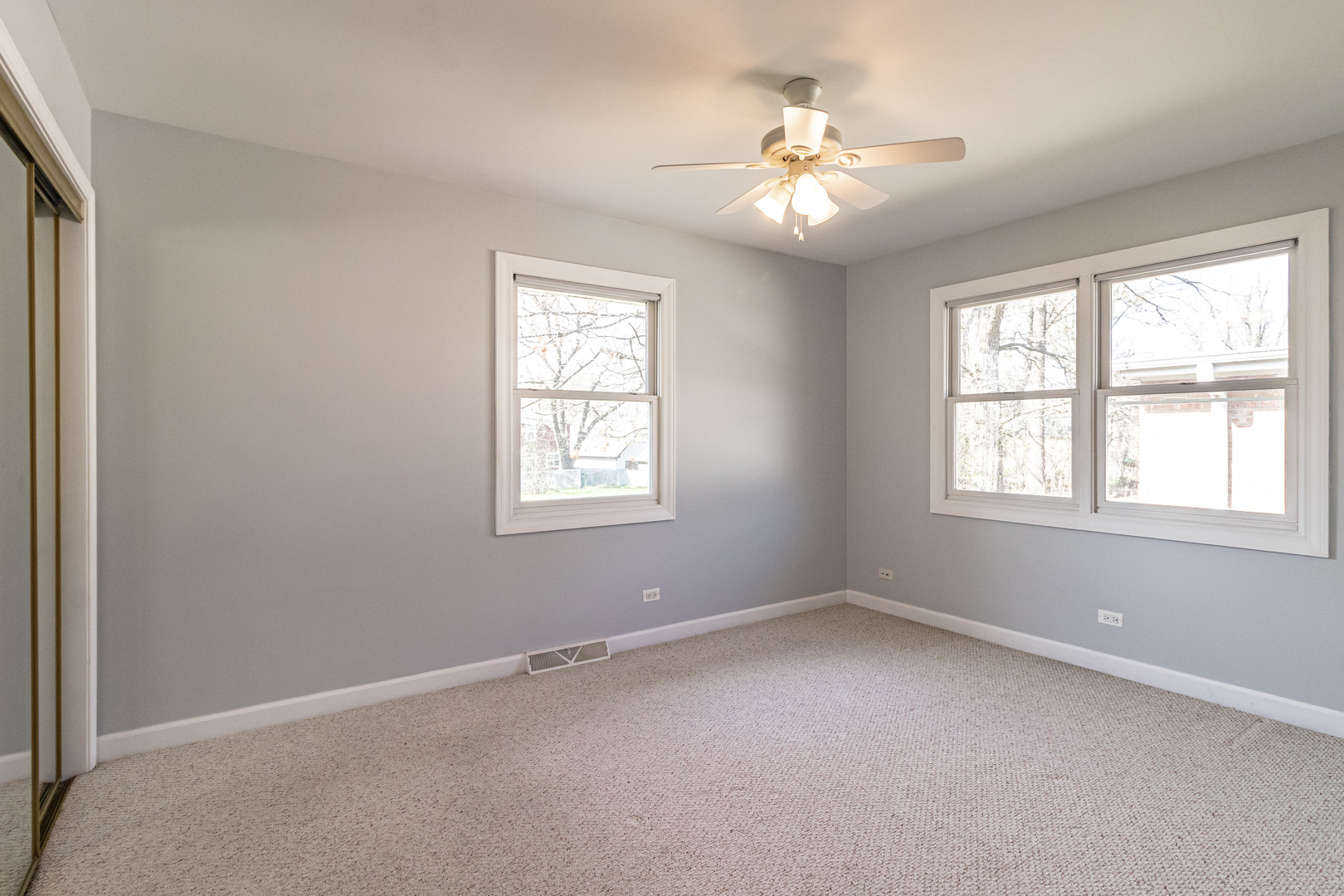 1979 Dundee Road Northbrook, IL 60062 - Photo 15 of 28 an empty room with windows and chandelier fan