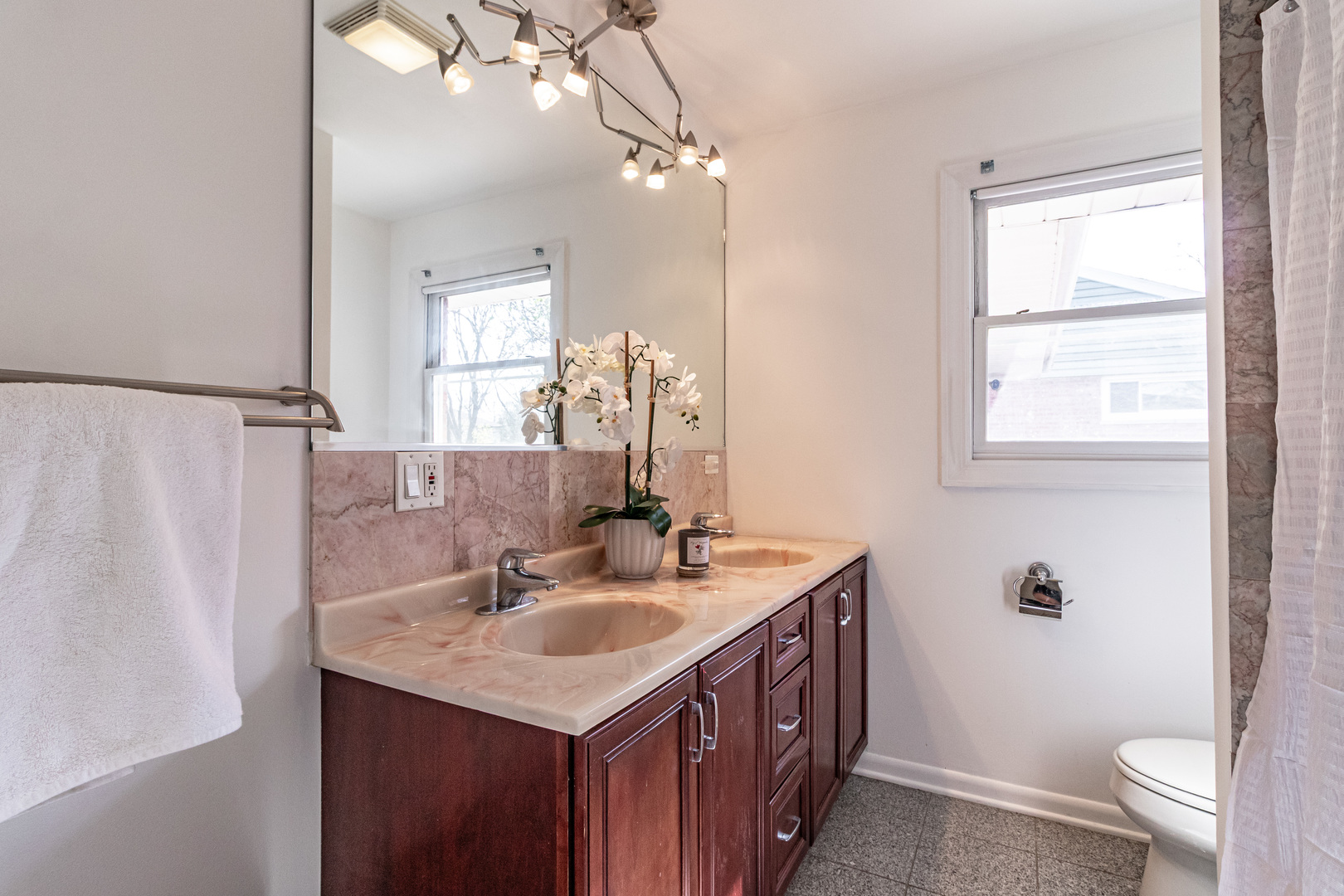 1979 Dundee Road Northbrook, IL 60062 - Photo 16 of 28 a bathroom with a sink a toilet and a mirror