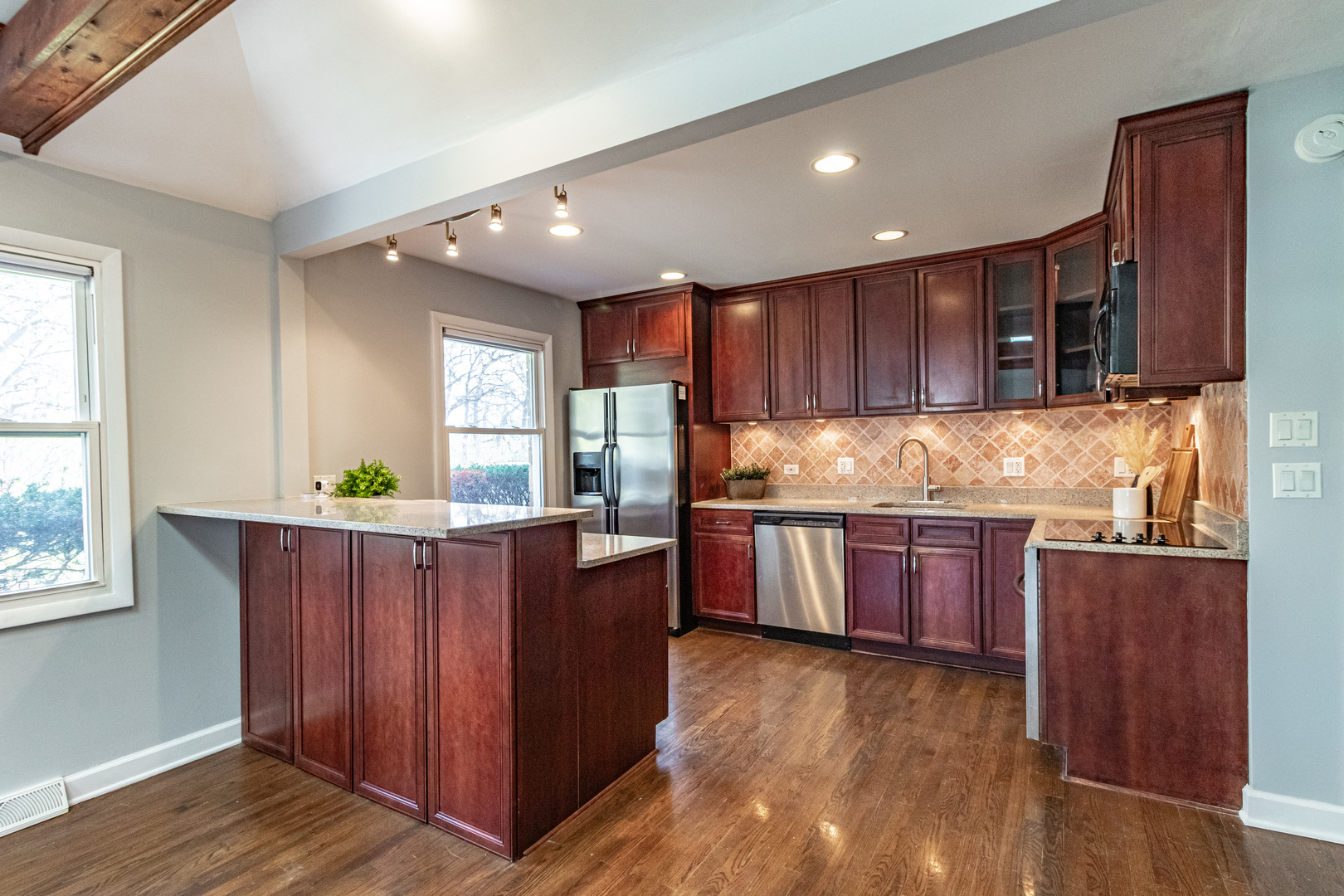 1979 Dundee Road Northbrook, IL 60062 - Photo 9 of 28 a kitchen with stainless steel appliances granite countertop wooden cabinets a stove and a sink