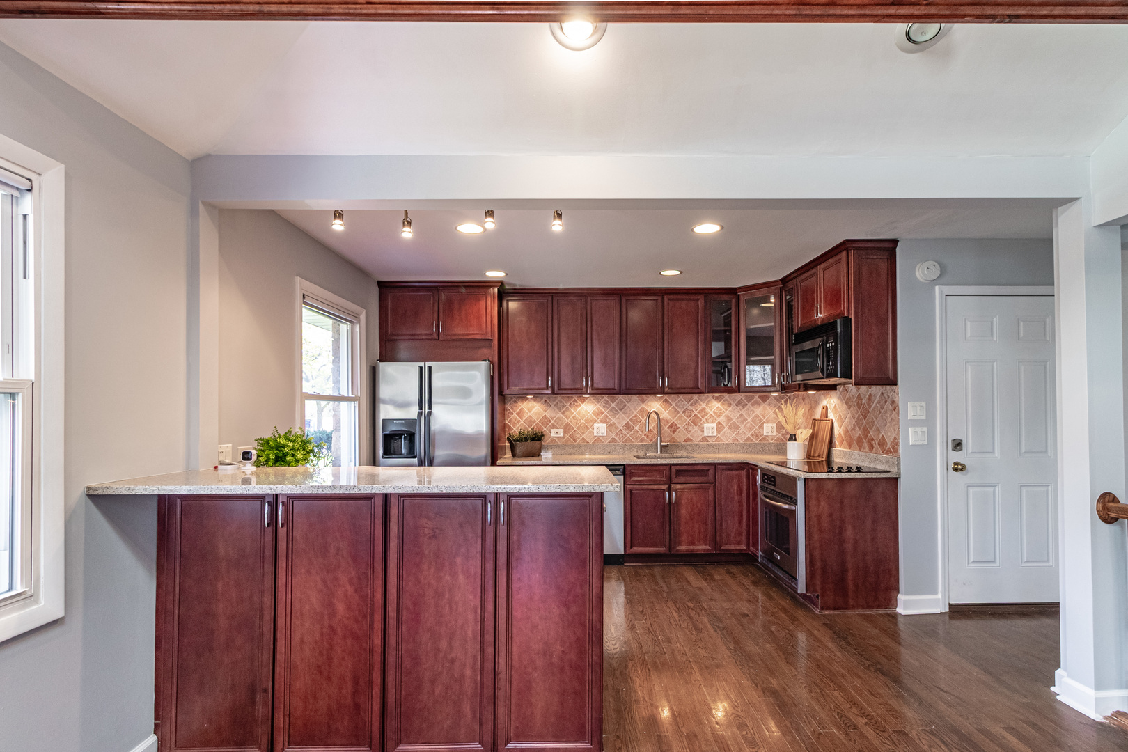 1979 Dundee Road Northbrook, IL 60062 - Photo 10 of 28 a kitchen with stainless steel appliances kitchen island granite countertop wooden cabinets and sink