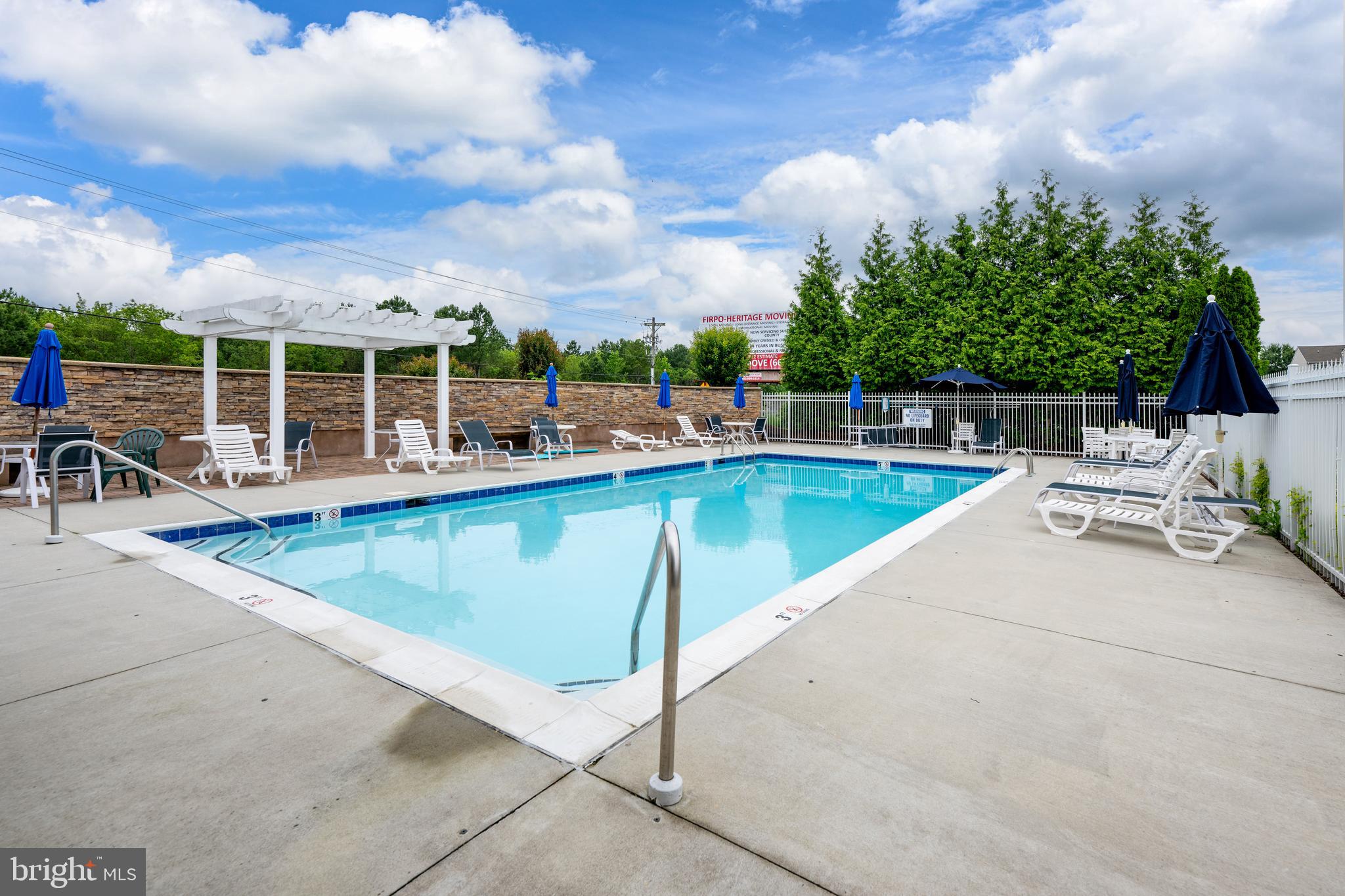 27548 Mayfield Road, Unit 42 Millsboro, DE 19966 - Photo 45 of 46 a view of a swimming pool with outdoor seating