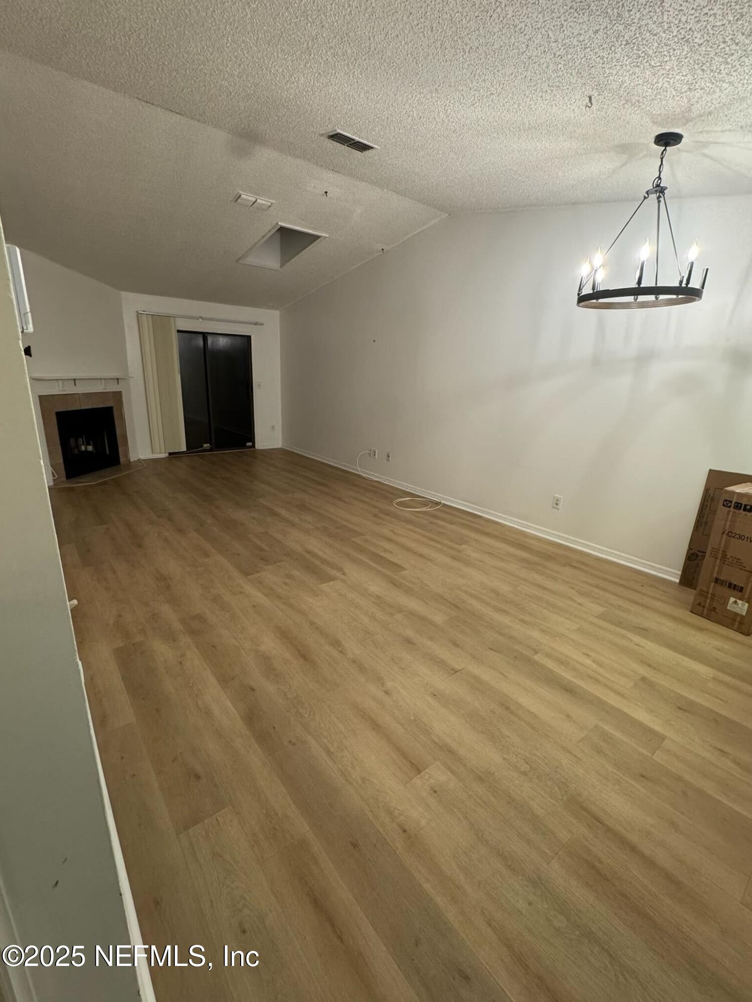 85 Debarry Avenue, Unit 1051 Orange Park, FL 32073 - Photo 2 of 8 a view of a room with wooden floor and a fireplace