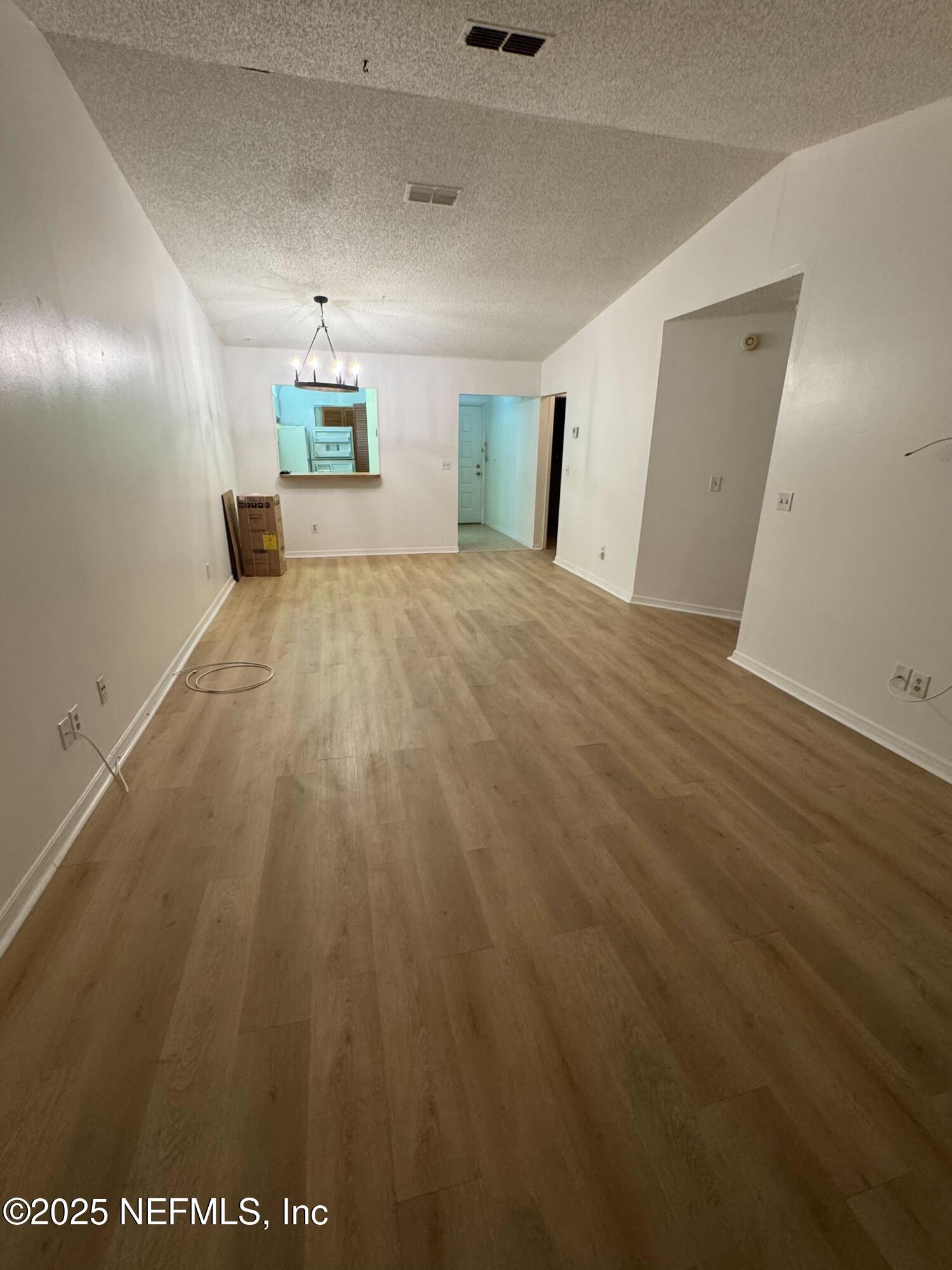 85 Debarry Avenue, Unit 1051 Orange Park, FL 32073 - Photo 3 of 8 a view of a big room with wooden floor and windows