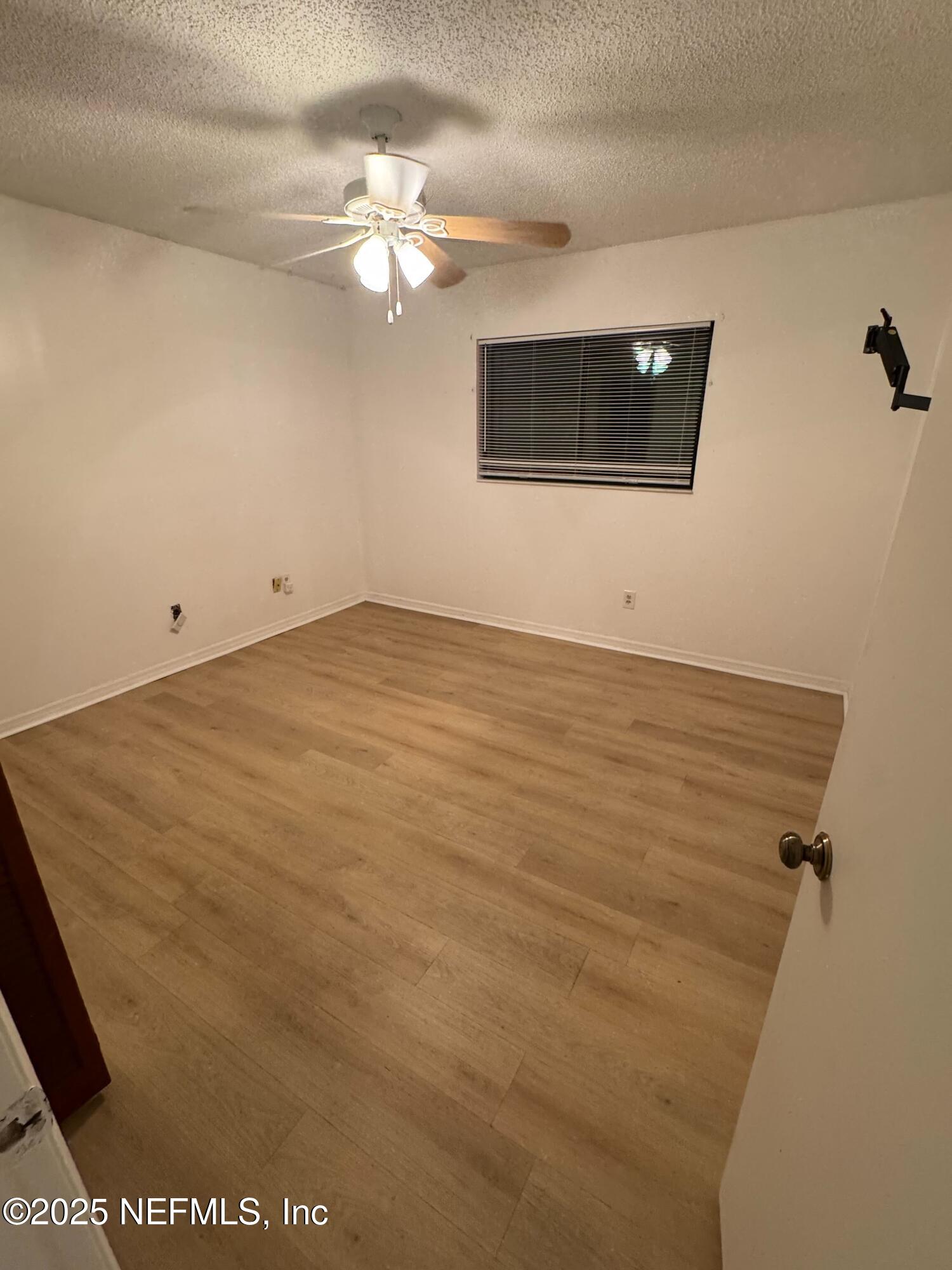 85 Debarry Avenue, Unit 1051 Orange Park, FL 32073 - Photo 4 of 8 a view of an empty room with a chandelier fan