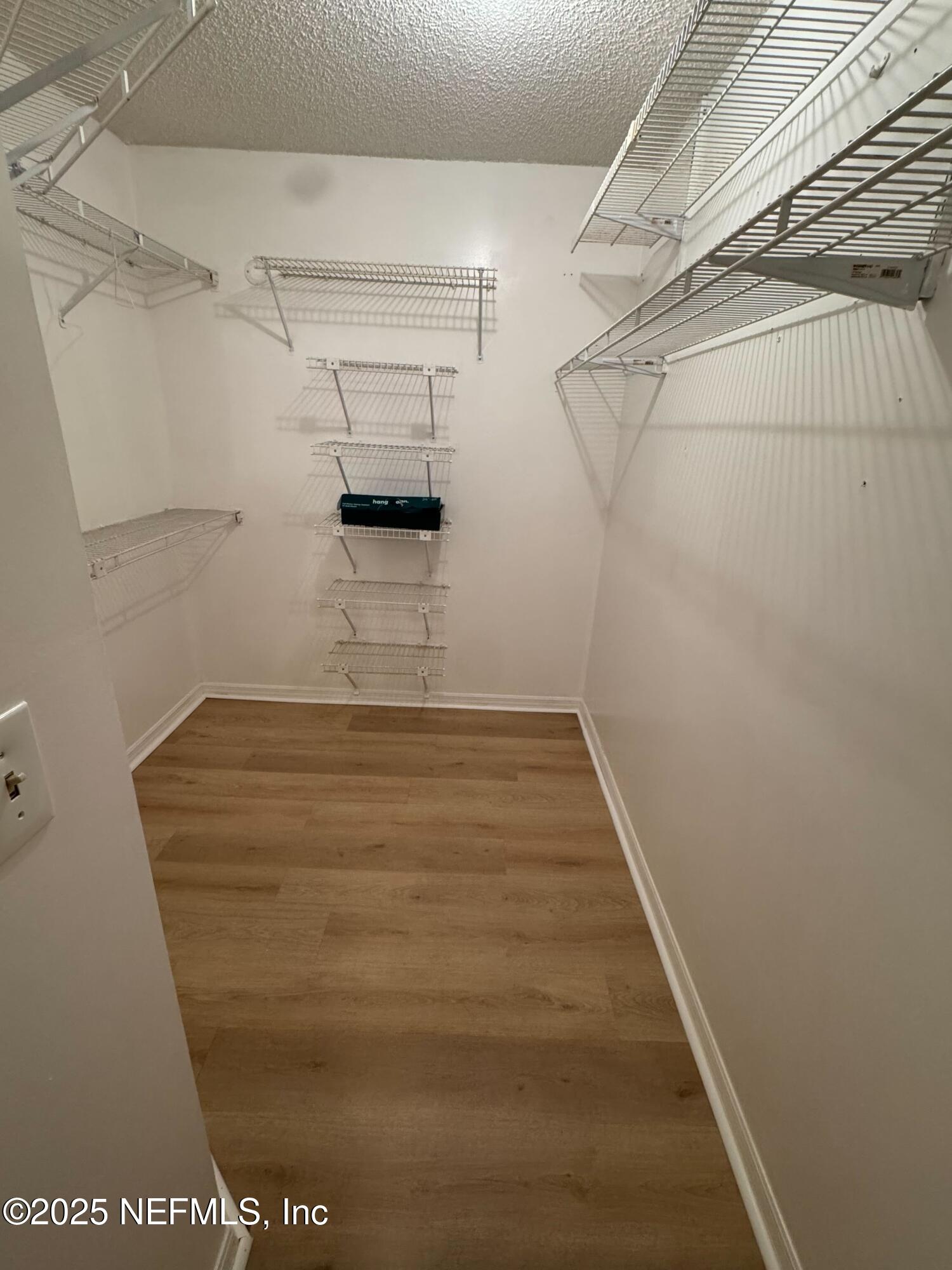 85 Debarry Avenue, Unit 1051 Orange Park, FL 32073 - Photo 7 of 8 a view of a room with racks on the wall