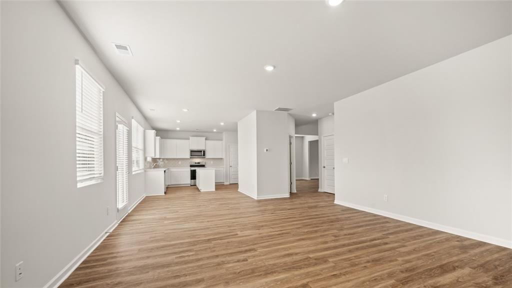 113 Oakchase Pk Lane Hampton, GA 30228 - Photo 12 of 34 a view of a big room with wooden floor and windows