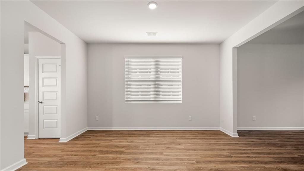113 Oakchase Pk Lane Hampton, GA 30228 - Photo 14 of 34 a view of an empty room with wooden floor and a window