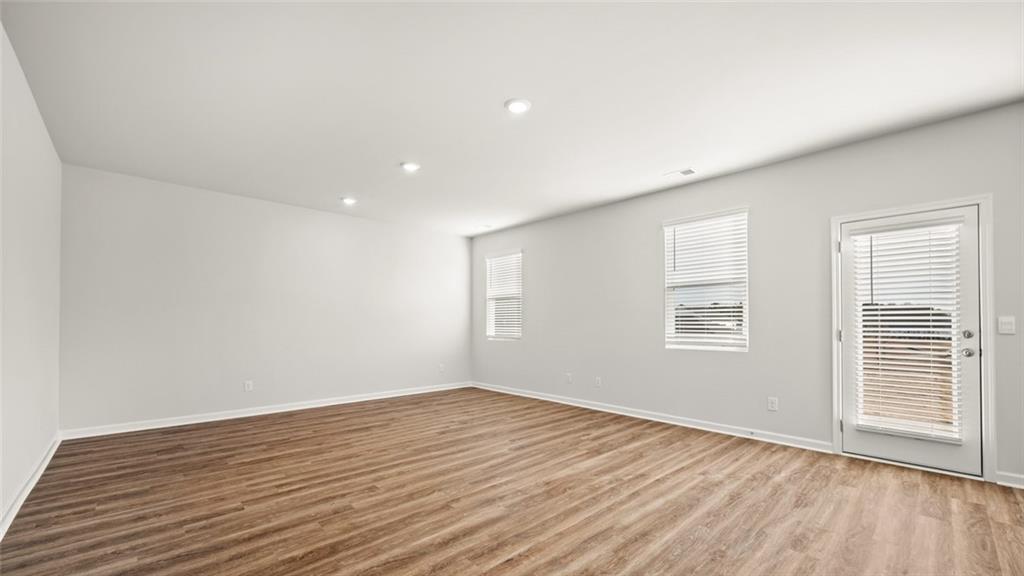 113 Oakchase Pk Lane Hampton, GA 30228 - Photo 15 of 34 a view of empty room with wooden floor and fan