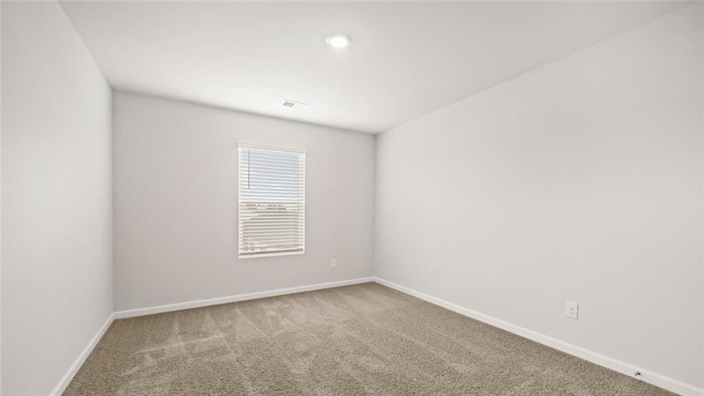 113 Oakchase Pk Lane Hampton, GA 30228 - Photo 17 of 34 an empty room with a window