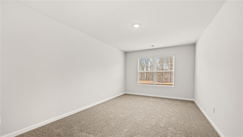 113 Oakchase Pk Lane Hampton, GA 30228 - Photo 20 of 34 a view of an empty room with a window