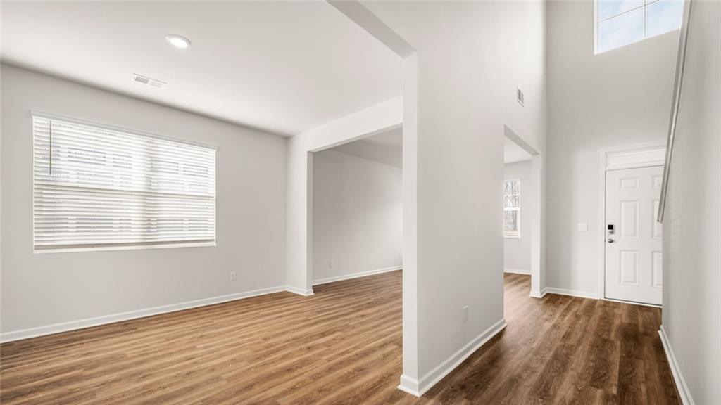 113 Oakchase Pk Lane Hampton, GA 30228 - Photo 2 of 34 a view of an empty room with wooden floor and a window