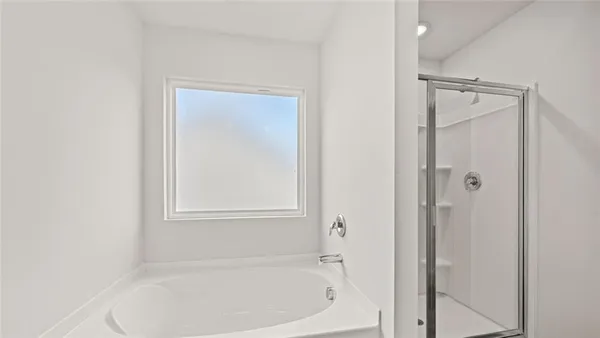 a white bath tub sitting next to a shower