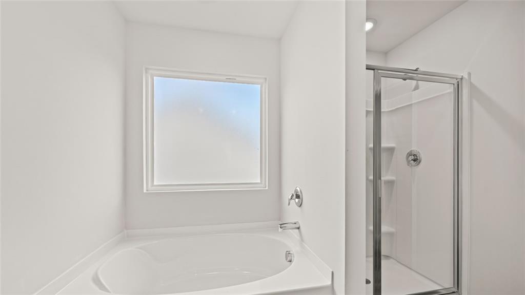 113 Oakchase Pk Lane Hampton, GA 30228 - Photo 26 of 34 a white bath tub sitting next to a shower