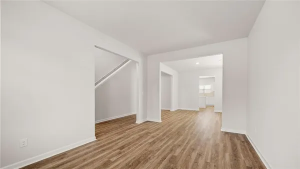 wooden floor in a hall with an empty room