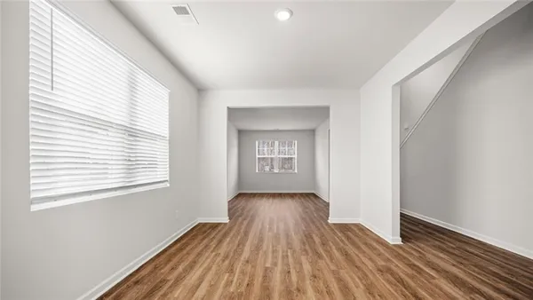 a view of a room with wooden floor and window