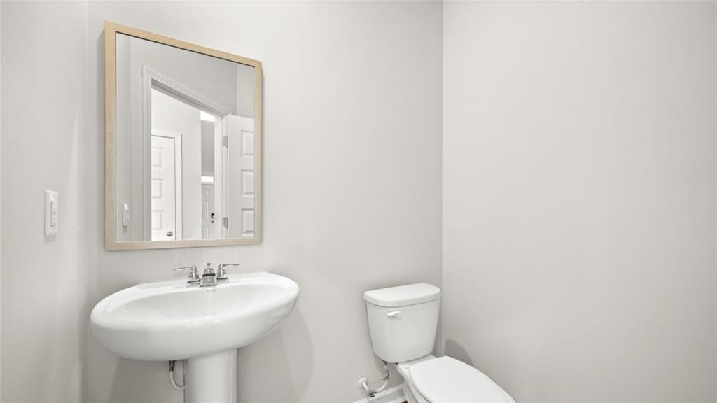 113 Oakchase Pk Lane Hampton, GA 30228 - Photo 7 of 34 a bathroom with a sink a toilet and mirror