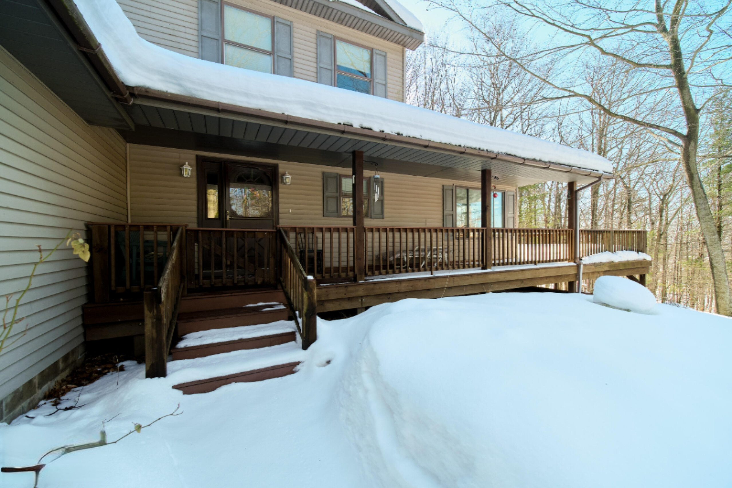 9800 Emerald Ridge Trail Onekama, MI 49675 - Photo 6 of 66 Inviting covered porch entrance