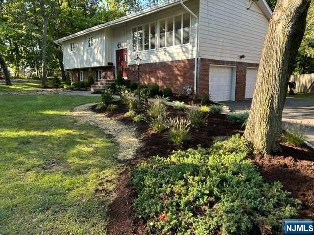 a view of a house with a yard and potted plants