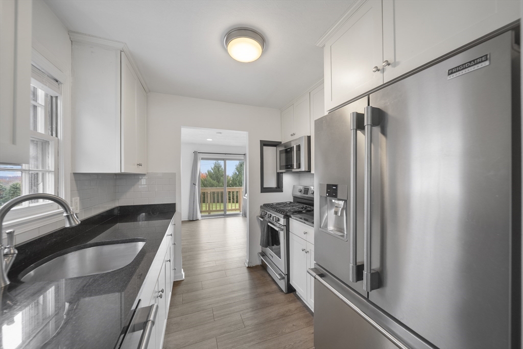 45 Washington Street, Unit 55 Methuen, MA 01844 - Photo 12 of 36 a kitchen with granite countertop a refrigerator stove and sink
