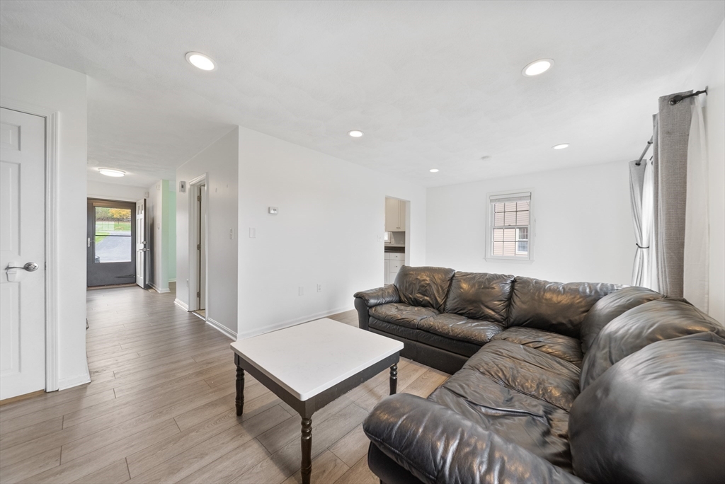 45 Washington Street, Unit 55 Methuen, MA 01844 - Photo 14 of 36 a living room with furniture a refrigerator and a couch