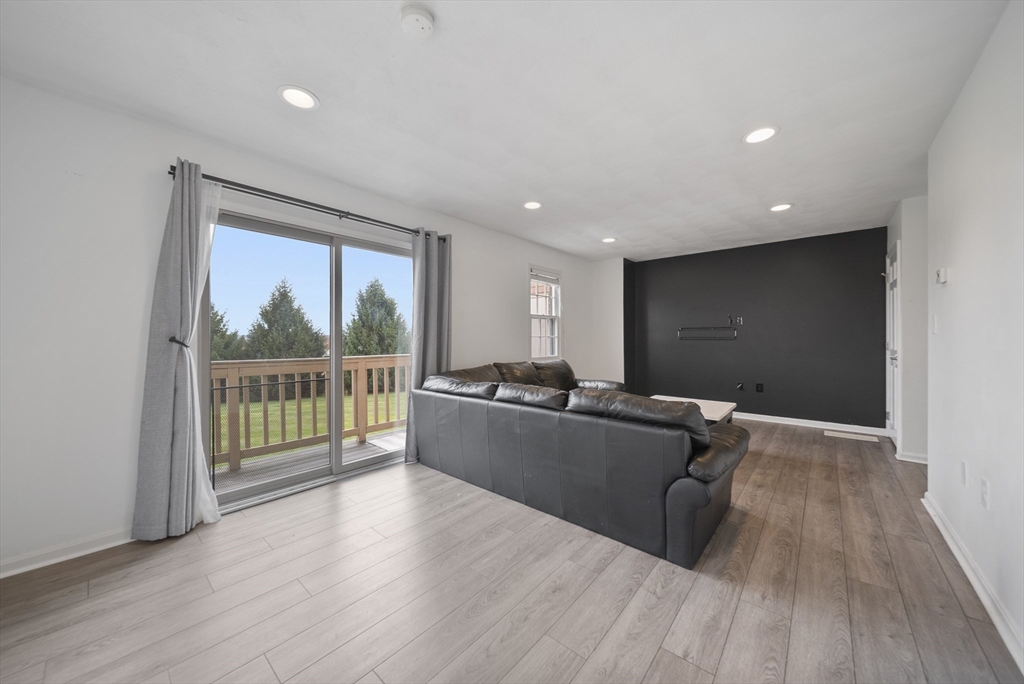 45 Washington Street, Unit 55 Methuen, MA 01844 - Photo 15 of 36 a living room with wooden floor and furniture