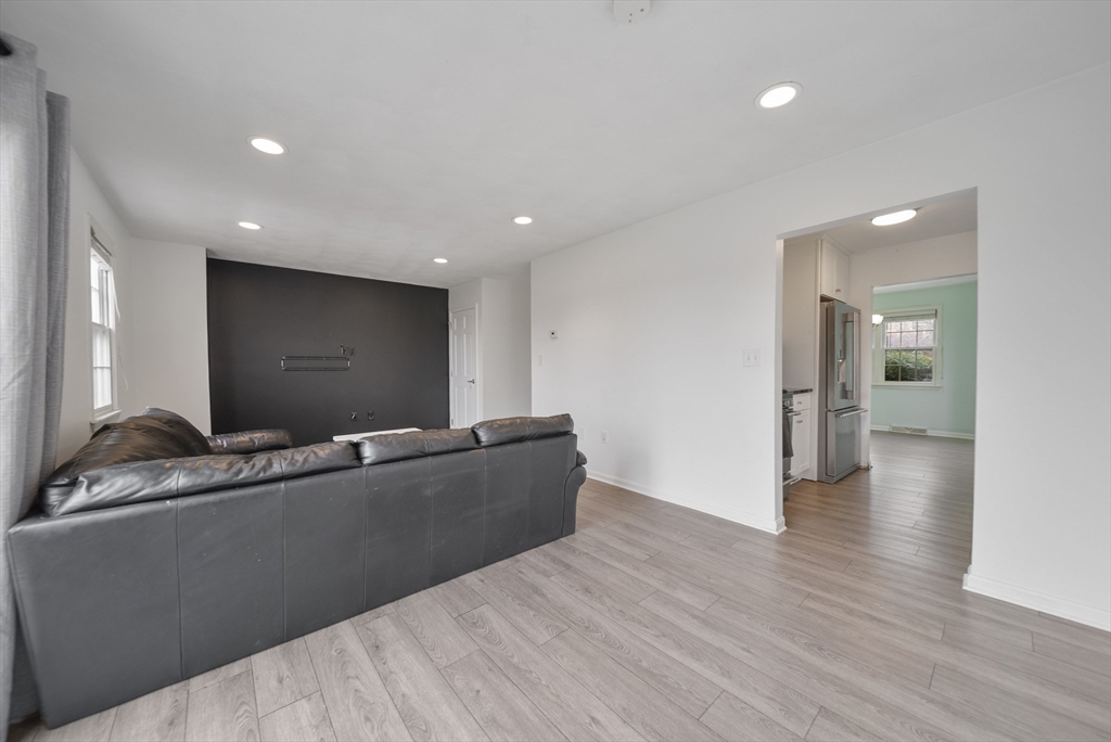 45 Washington Street, Unit 55 Methuen, MA 01844 - Photo 16 of 36 a living room with granite countertop furniture and a flat screen tv