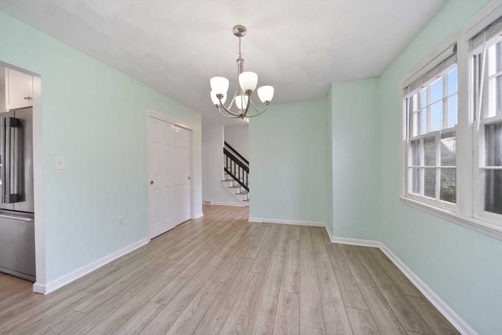 45 Washington Street, Unit 55 Methuen, MA 01844 - Photo 6 of 36 a view of a room with wooden floor and chandelier
