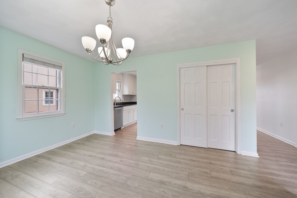 45 Washington Street, Unit 55 Methuen, MA 01844 - Photo 8 of 36 a view of an empty room with wooden floor and a window