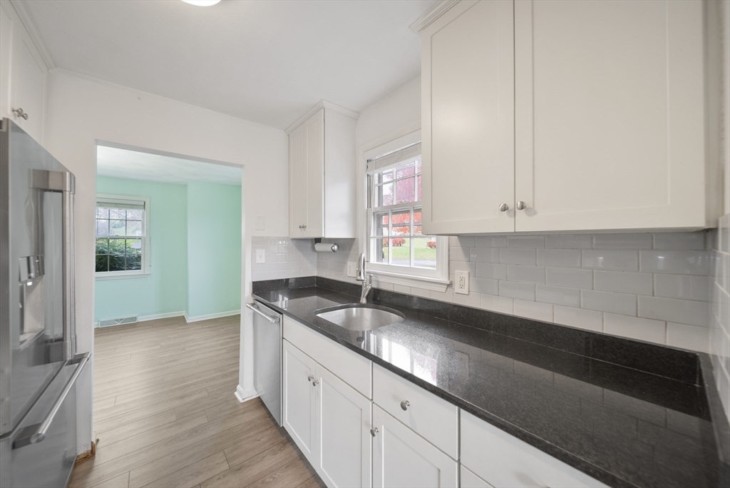 45 Washington Street, Unit 55 Methuen, MA 01844 - Photo 9 of 36 a kitchen with granite countertop white cabinets and a sink