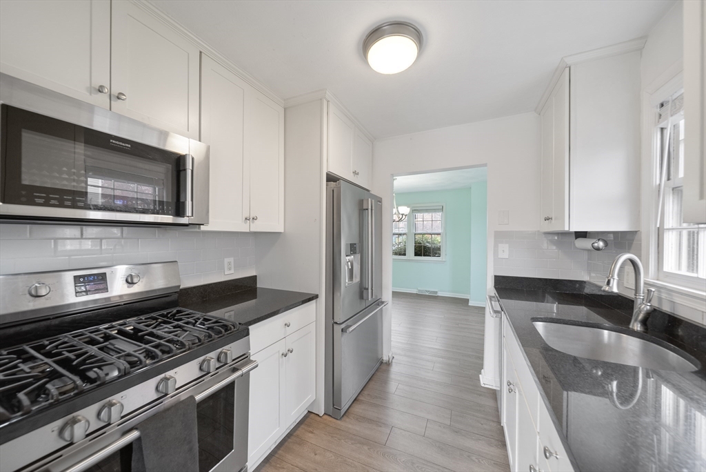 45 Washington Street, Unit 55 Methuen, MA 01844 - Photo 10 of 36 a kitchen with stainless steel appliances granite countertop a sink stove and microwave