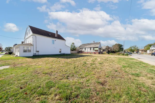 a view of an house with swimming pool and sitting area