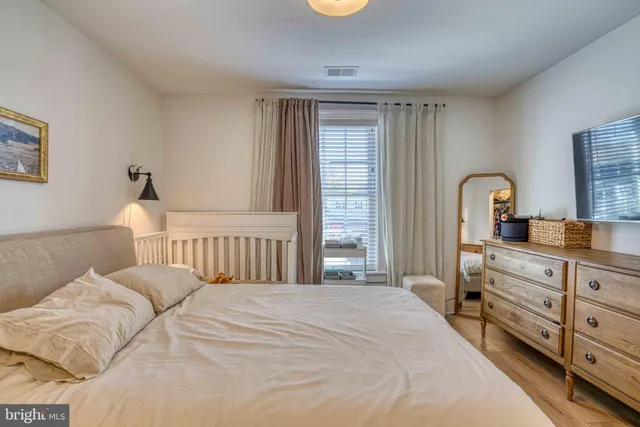 a bedroom with a bed next to a window with outer view