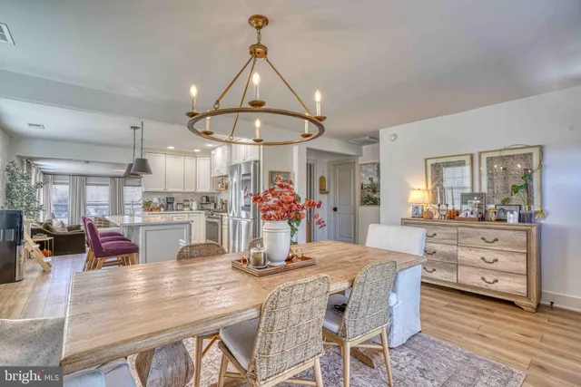 a kitchen and a dining room with wooden floor