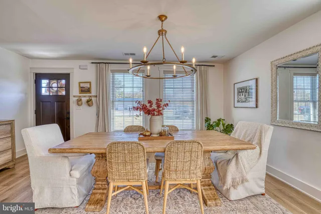 a view of a dining room with furniture wooden floor and chandelier