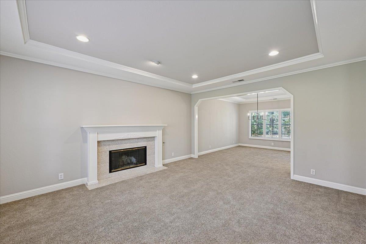 4608 Danvers Lane Granite Bay, CA 95746 - Photo 12 of 74 an empty room with a fireplace and windows