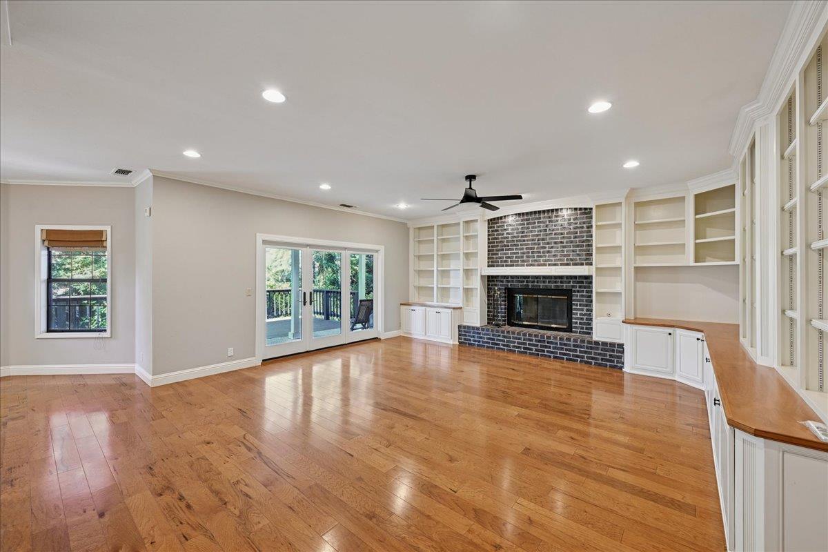 4608 Danvers Lane Granite Bay, CA 95746 - Photo 28 of 74 a view of an empty room with wooden floor fireplace and a window