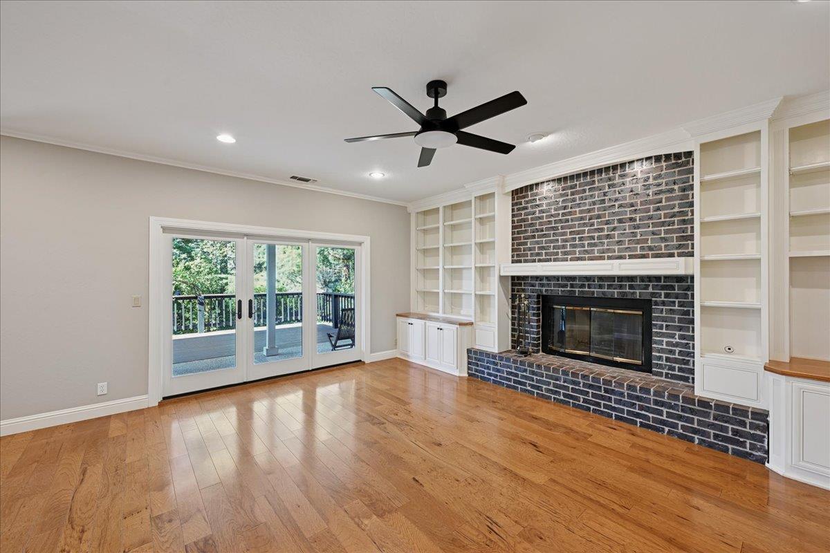 4608 Danvers Lane Granite Bay, CA 95746 - Photo 29 of 74 a view of empty room with wooden floor and a fireplace