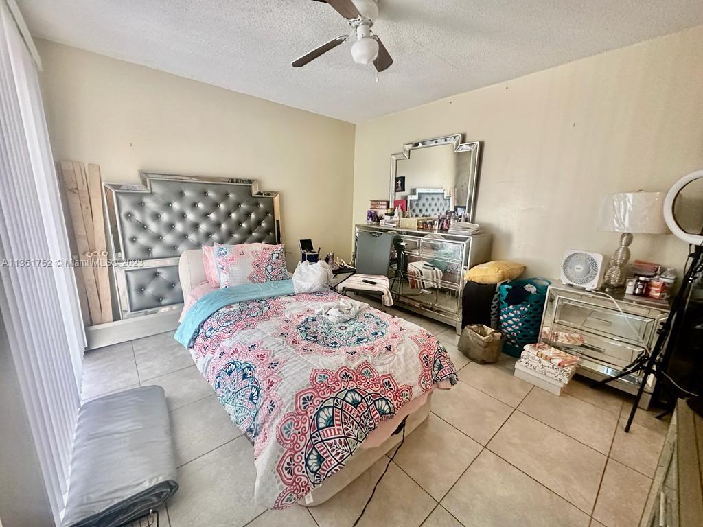 3199 Foxcroft Road, Unit 309 Miramar, FL 33025 - Photo 13 of 21 a bedroom with furniture and a bed